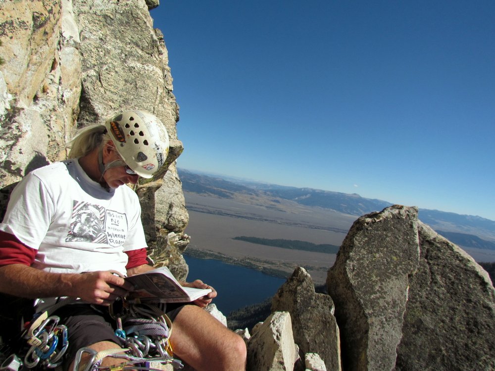 Matt reading the guidebook between pitches