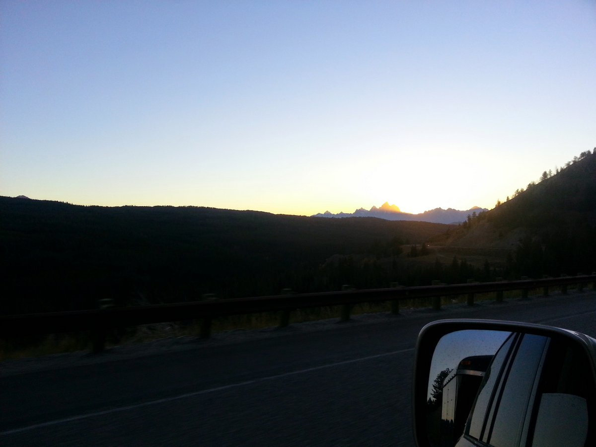 Sunset over the tetons from a car on Togwotee Pass