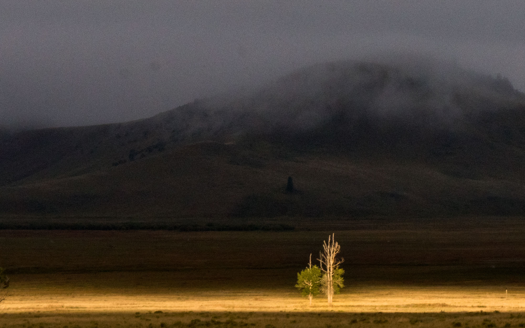 The sun breaks clouds on Elk Refuge Road