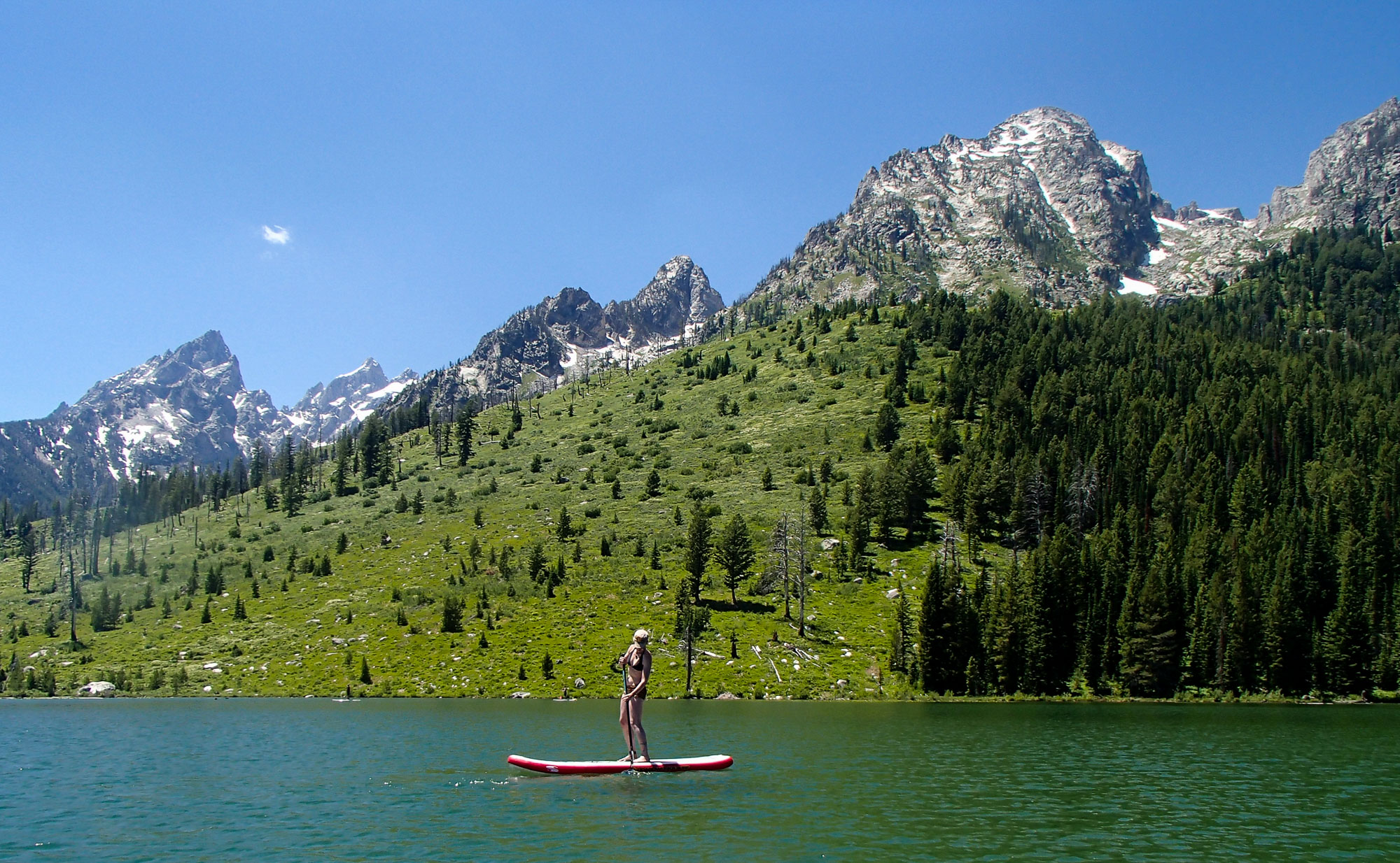 Big D paddles in front of Teewinot at String Lake